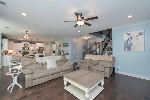 living area featuring stairway, dark wood-style floors, ornamental molding, and visible vents