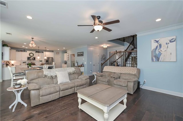 living area with dark wood-type flooring, stairs, ornamental molding, and ceiling fan