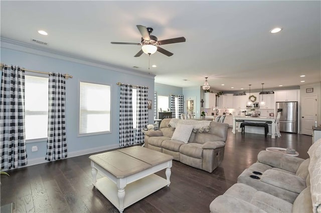 living area featuring a ceiling fan, visible vents, recessed lighting, and crown molding
