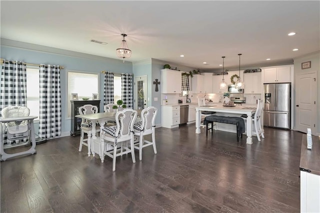 dining room with crown molding, visible vents, recessed lighting, and dark wood-type flooring