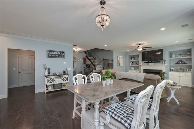 dining area featuring visible vents, dark wood-style flooring, crown molding, and stairway