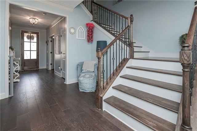 entryway featuring ornamental molding, stairs, baseboards, and wood finished floors