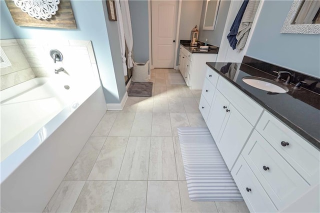 full bathroom with a sink, a garden tub, and two vanities