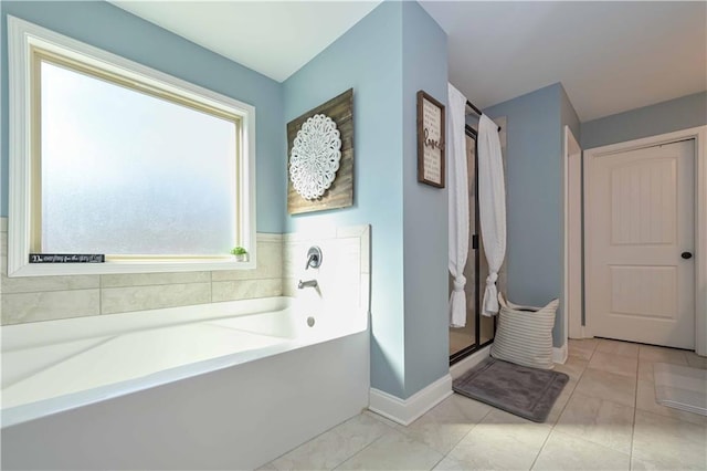 full bathroom featuring a shower stall, baseboards, and a garden tub