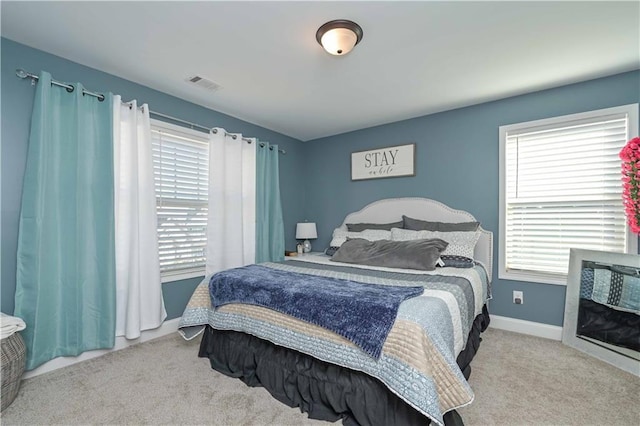 carpeted bedroom with baseboards and visible vents