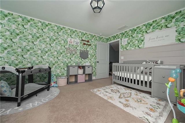 bedroom featuring visible vents, carpet, and wallpapered walls