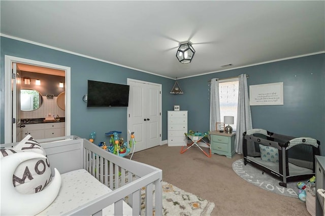 carpeted bedroom with visible vents, a closet, and ornamental molding