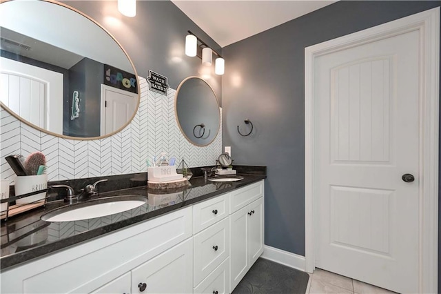 full bathroom with a sink, tile patterned floors, and backsplash