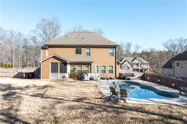 rear view of property featuring a fenced backyard, a patio, outdoor lounge area, and a fenced in pool