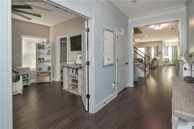 corridor with visible vents, ornamental molding, dark wood-style floors, baseboards, and stairs