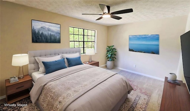 bedroom with carpet flooring, a textured ceiling, baseboards, and a ceiling fan