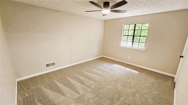 carpeted empty room featuring a ceiling fan, baseboards, visible vents, and a textured ceiling