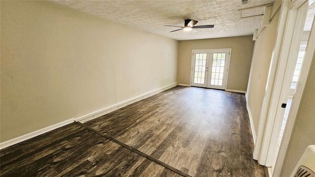 unfurnished room featuring baseboards, dark wood-type flooring, a textured ceiling, french doors, and a ceiling fan