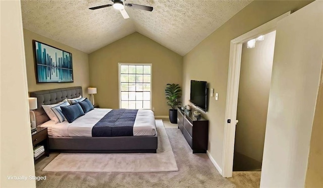 bedroom featuring baseboards, a textured ceiling, a ceiling fan, carpet, and vaulted ceiling