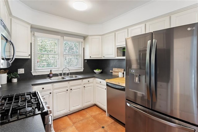 kitchen featuring stainless steel appliances, sink, white cabinets, and decorative backsplash