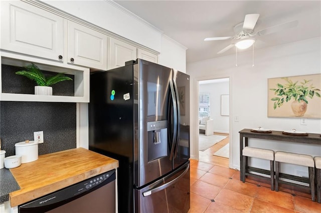 kitchen featuring butcher block counters, white cabinetry, light tile patterned floors, appliances with stainless steel finishes, and ceiling fan