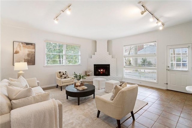 tiled living room with a brick fireplace