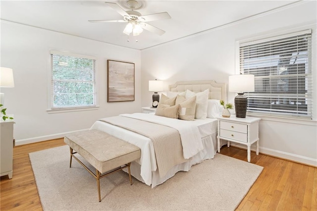 bedroom with ceiling fan and light wood-type flooring