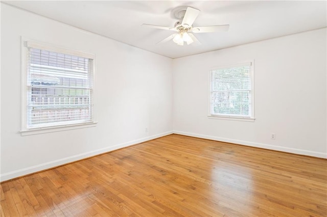 spare room featuring hardwood / wood-style floors and ceiling fan