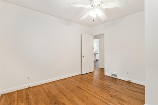 spare room with wood-type flooring and ceiling fan