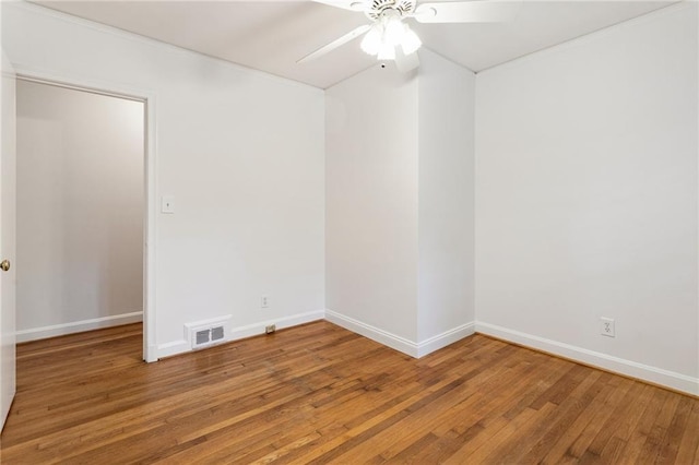 spare room with ceiling fan and wood-type flooring