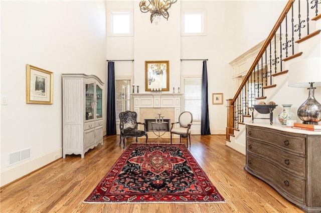 5352 Lacosta Ln, Alpharetta, GA 30022 - foyer entrance with a high ceiling, stairs, baseboards, and light wood-type flooring