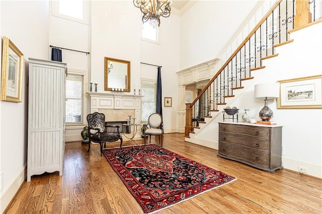 5352 Lacosta Ln, Alpharetta, GA 30022 - entrance foyer with stairway, a fireplace, baseboards, wood finished floors, and a high ceiling
