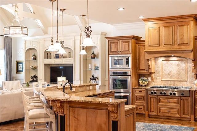 5352 Lacosta Ln, Alpharetta, GA 30022 - kitchen with open floor plan, stainless steel appliances, light stone counters, a kitchen bar, and recessed lighting
