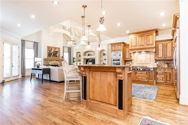 5352 Lacosta Ln, Alpharetta, GA 30022 - kitchen with stainless steel appliances, open floor plan, a kitchen breakfast bar, decorative backsplash, and recessed lighting