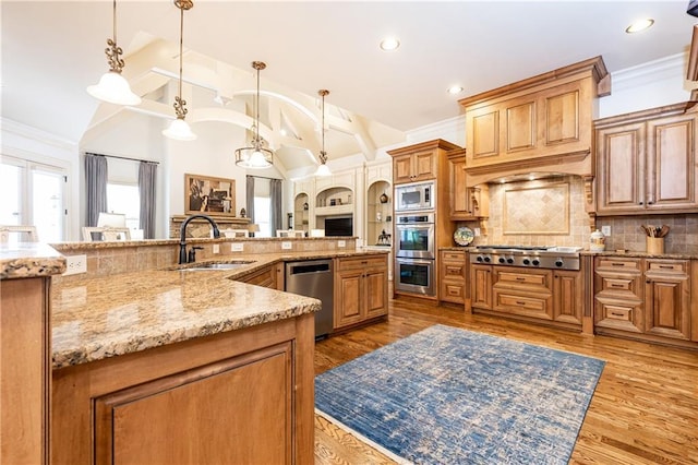 5352 Lacosta Ln, Alpharetta, GA 30022 - kitchen with stainless steel appliances, a sink, backsplash, light stone counters, and pendant lighting
