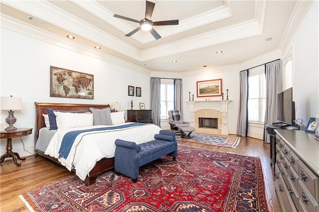 5352 Lacosta Ln, Alpharetta, GA 30022 - bedroom featuring wood finished floors, ornamental molding, a fireplace, and a raised ceiling