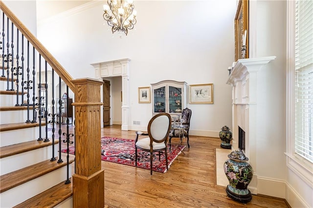 5352 Lacosta Ln, Alpharetta, GA 30022 - foyer entrance with light wood finished floors, stairway, a fireplace with flush hearth, baseboards, and a chandelier