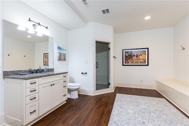 5352 Lacosta Ln, Alpharetta, GA 30022 - full bathroom with wood finished floors, toilet, vanity, baseboards, and a shower stall