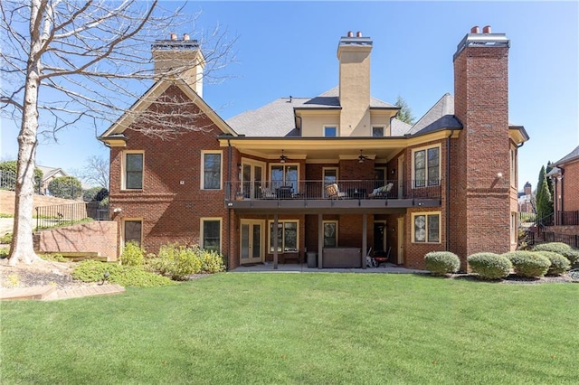 5352 Lacosta Ln, Alpharetta, GA 30022 - back of house featuring ceiling fan, a chimney, a lawn, and a patio