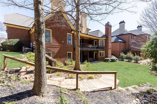 5352 Lacosta Ln, Alpharetta, GA 30022 - back of house featuring brick siding, a balcony, a lawn, and a chimney