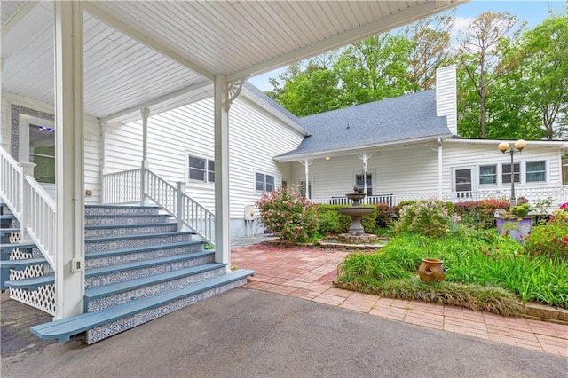 exterior space with covered porch and stairs