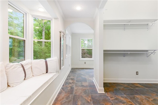 interior space with stone tile flooring and arched walkways