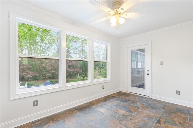 unfurnished room featuring baseboards, ornamental molding, ceiling fan, and stone finish floor