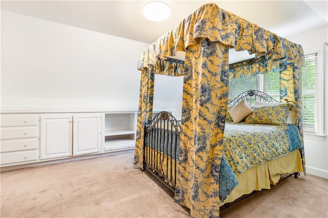 bedroom featuring light carpet