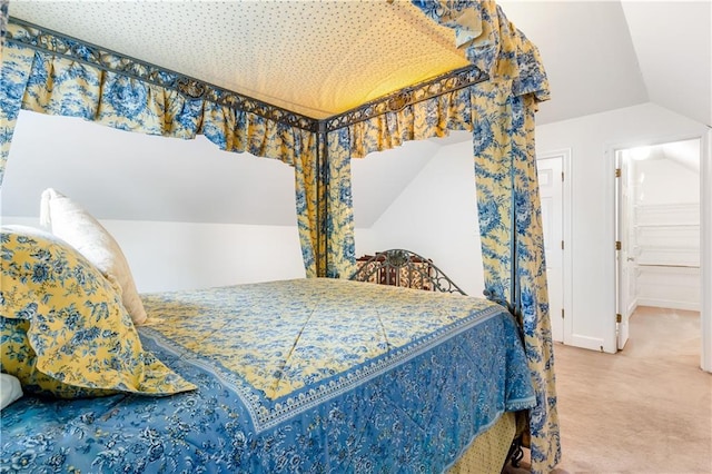 carpeted bedroom with lofted ceiling
