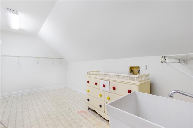 laundry area featuring laundry area, baseboards, light floors, a sink, and washer hookup