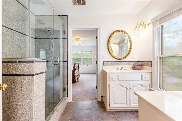 full bathroom with a ceiling fan, visible vents, tile patterned flooring, a shower stall, and vanity