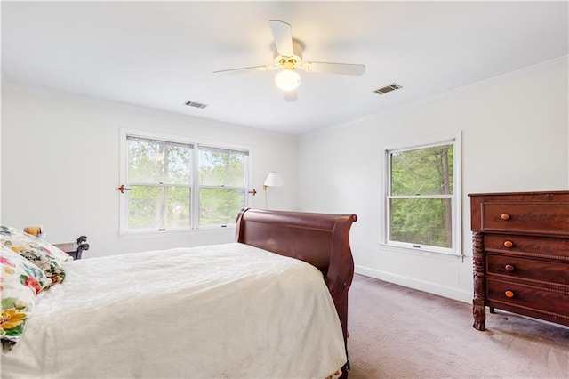 bedroom featuring crown molding, carpet flooring, and visible vents