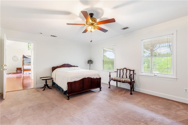 bedroom featuring baseboards, ornamental molding, light colored carpet, and visible vents