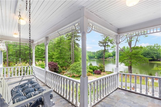 view of patio / terrace featuring a water view and covered porch