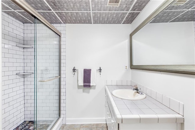 bathroom featuring vanity, a shower stall, tile patterned floors, and visible vents