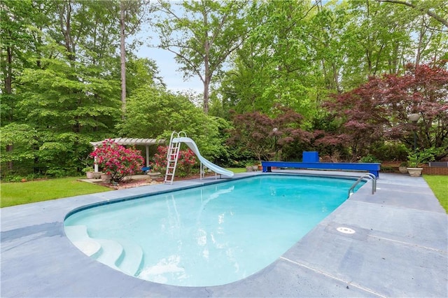 view of swimming pool with a water slide and a covered pool