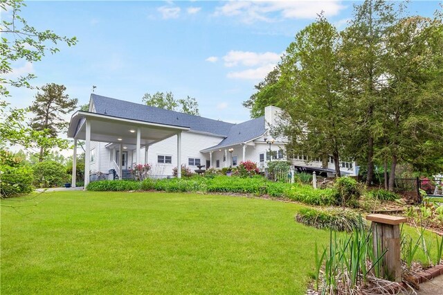 back of house featuring a yard