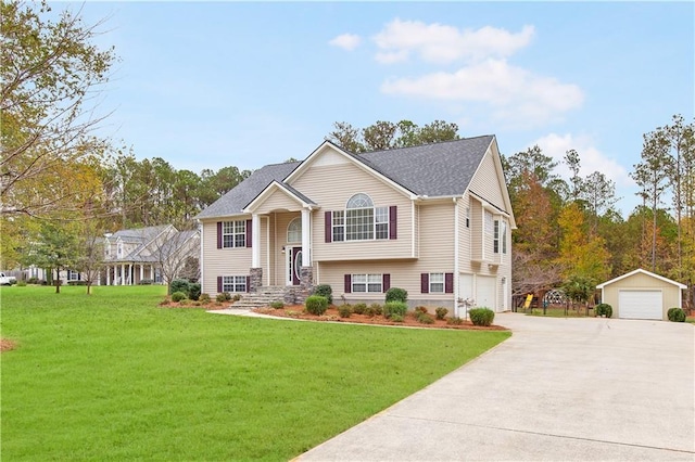 raised ranch with a garage, an outbuilding, and a front lawn