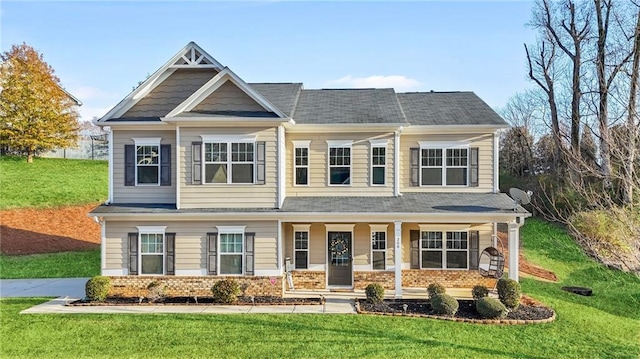 craftsman-style house with covered porch and a front lawn